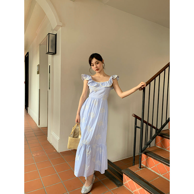 Beautiful embroidered high-waisted swinging ruffle-edged sleeveless dress
