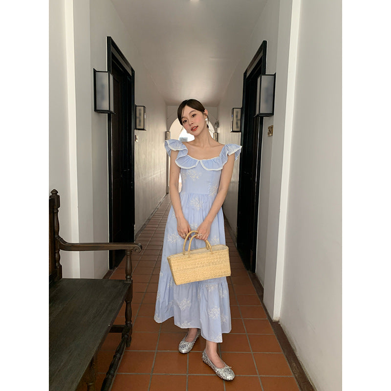 Beautiful embroidered high-waisted swinging ruffle-edged sleeveless dress