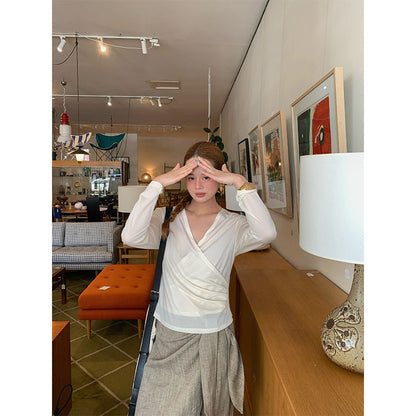Spring French age-reducing cross V-neck long-sleeved irregular hem bottoming shirt