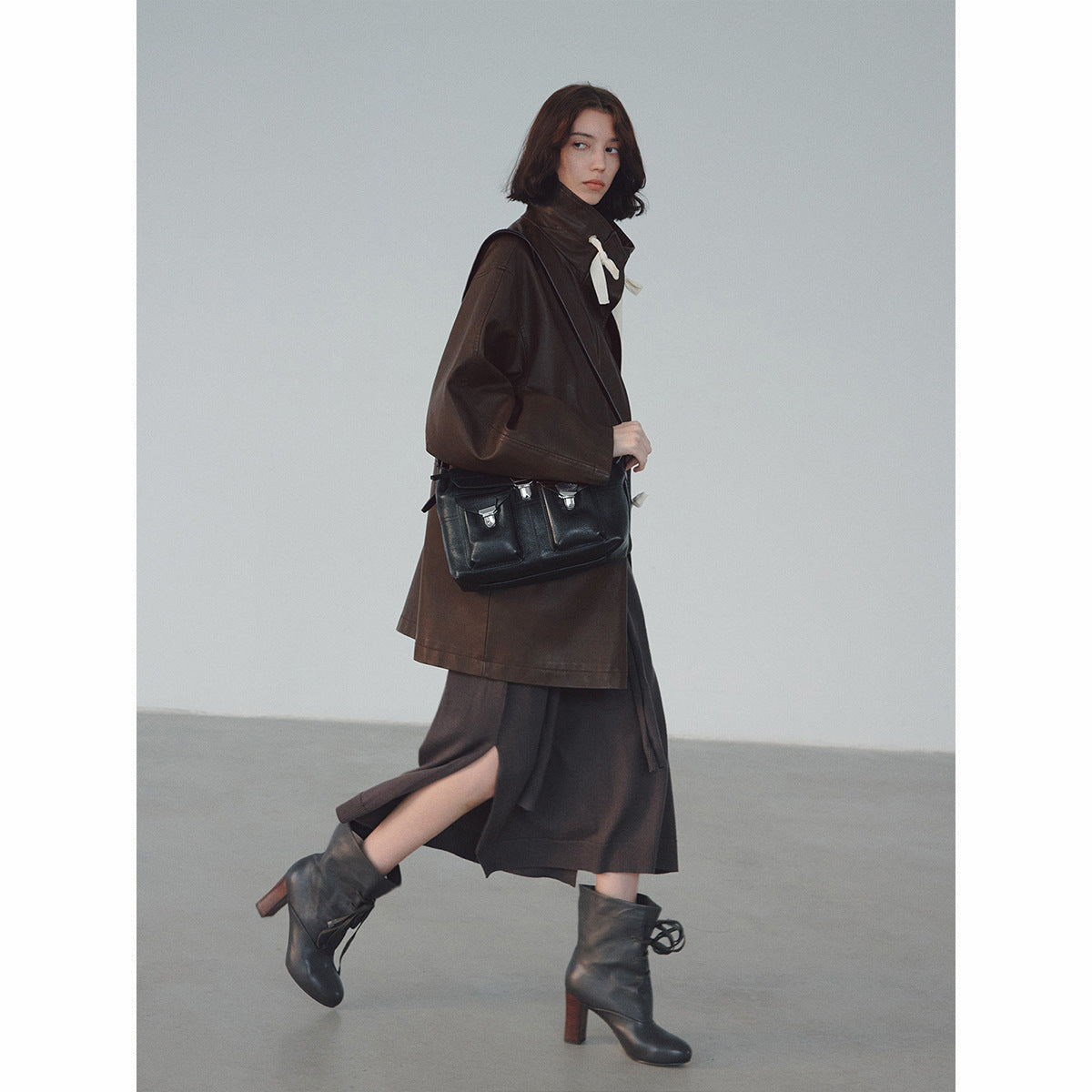 Stand-up collar streamer waist PU leather jacket, early spring new loose long commuter textured jacket