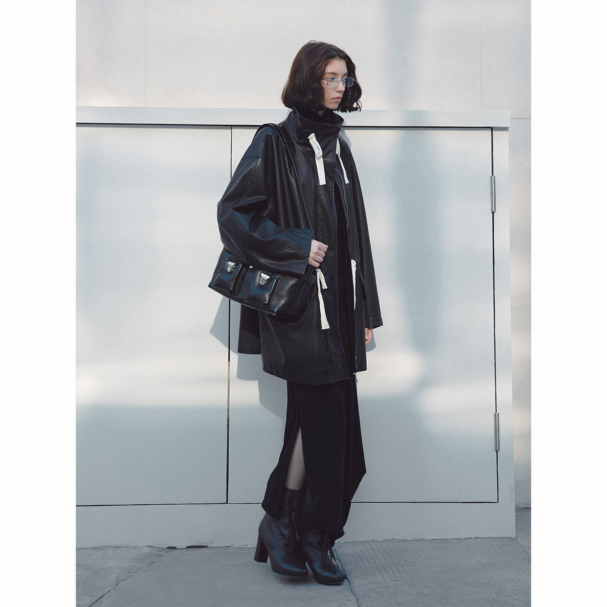 Stand-up collar streamer waist PU leather jacket, early spring new loose long commuter textured jacket