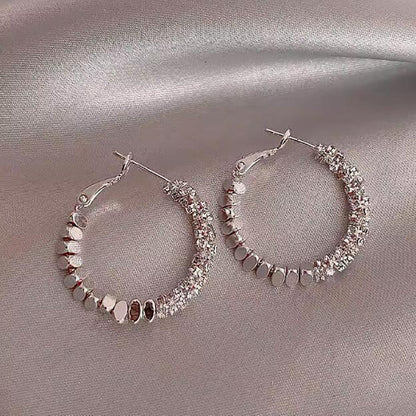 Broken silver unique circle earrings women's niche light luxury design ear buckle 2024 new popular high-end earrings